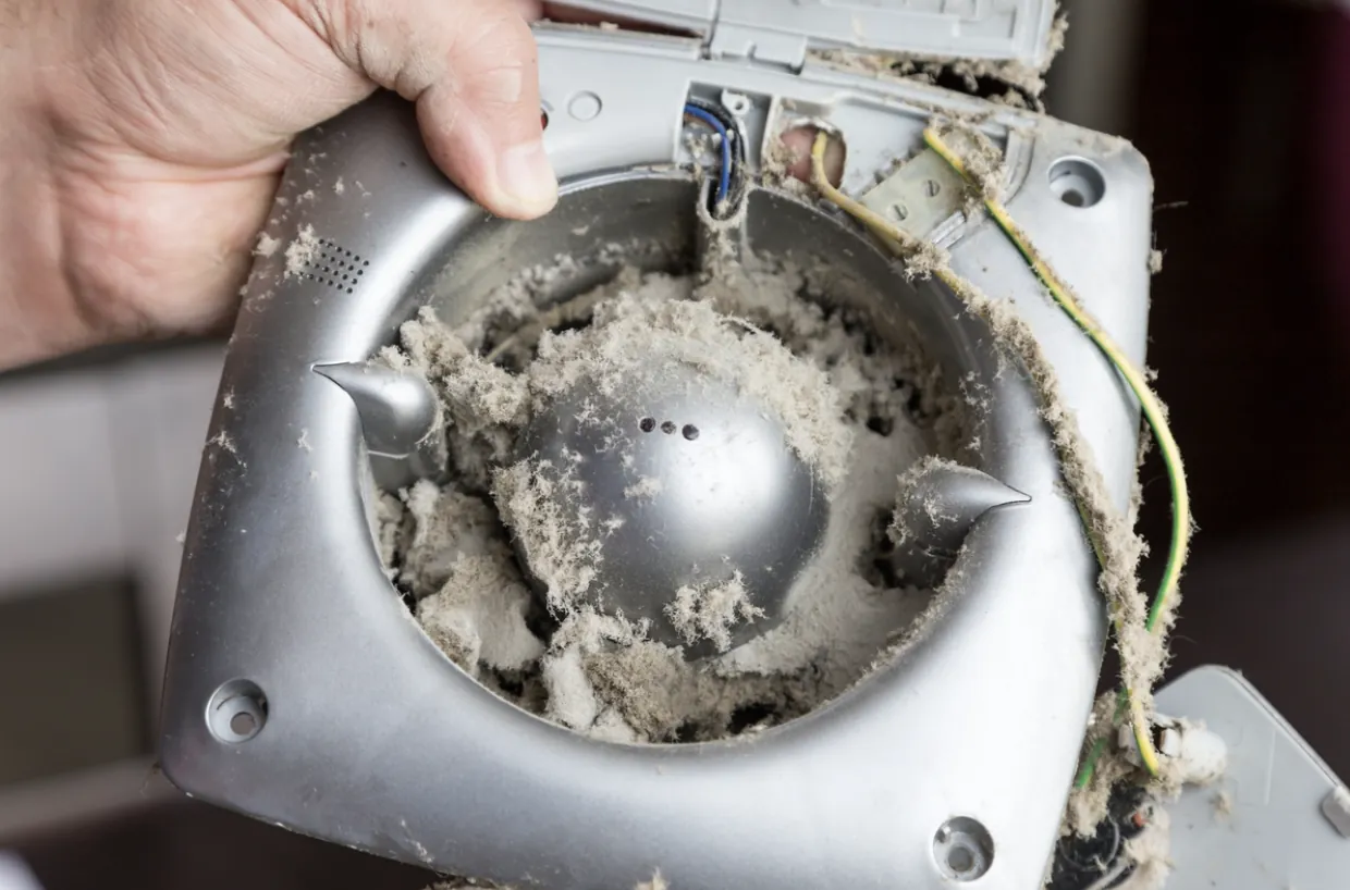 A close-up of a heavily clogged dryer vent showing dangerous lint accumulation that requires professional cleaning to prevent home fires in San Fernando.